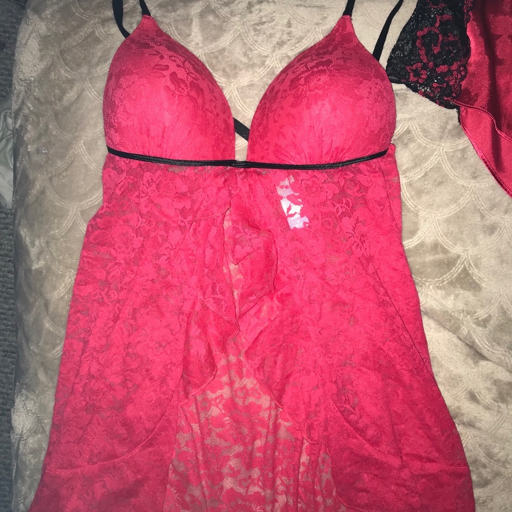 Bundle of red lace and silk pajamas and bra set